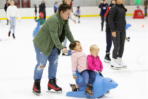 People (mother and children) enjoying ice skating 